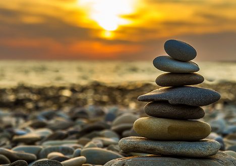cairn rocks beach sea calm sand sunset