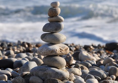 cairn rocks beach sea calm sand sun