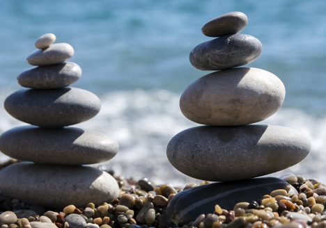 cairn rocks beach sea calm sand sun
